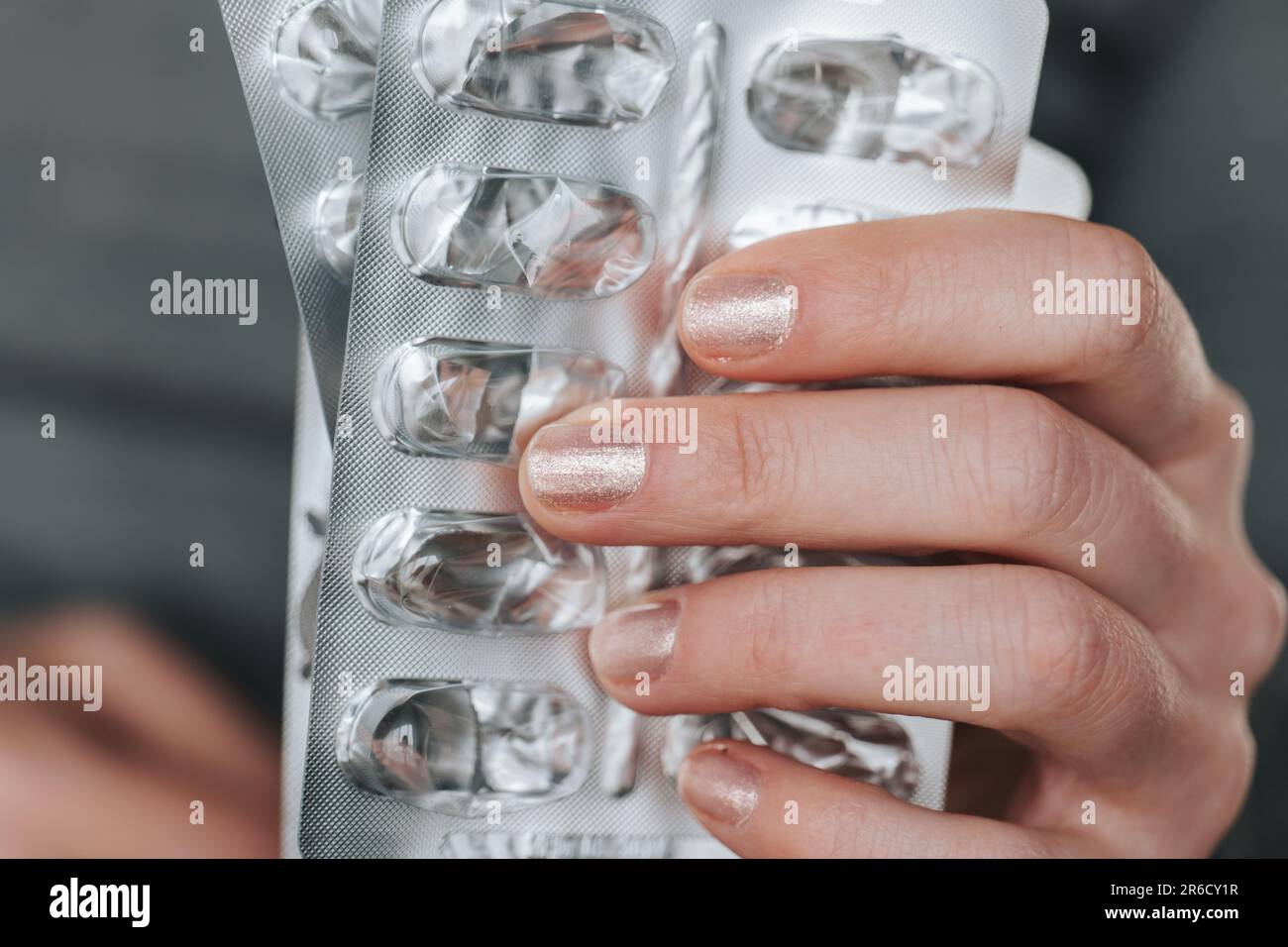 Lack of medicines.Empty shiny blisters from medicines in female hands ...