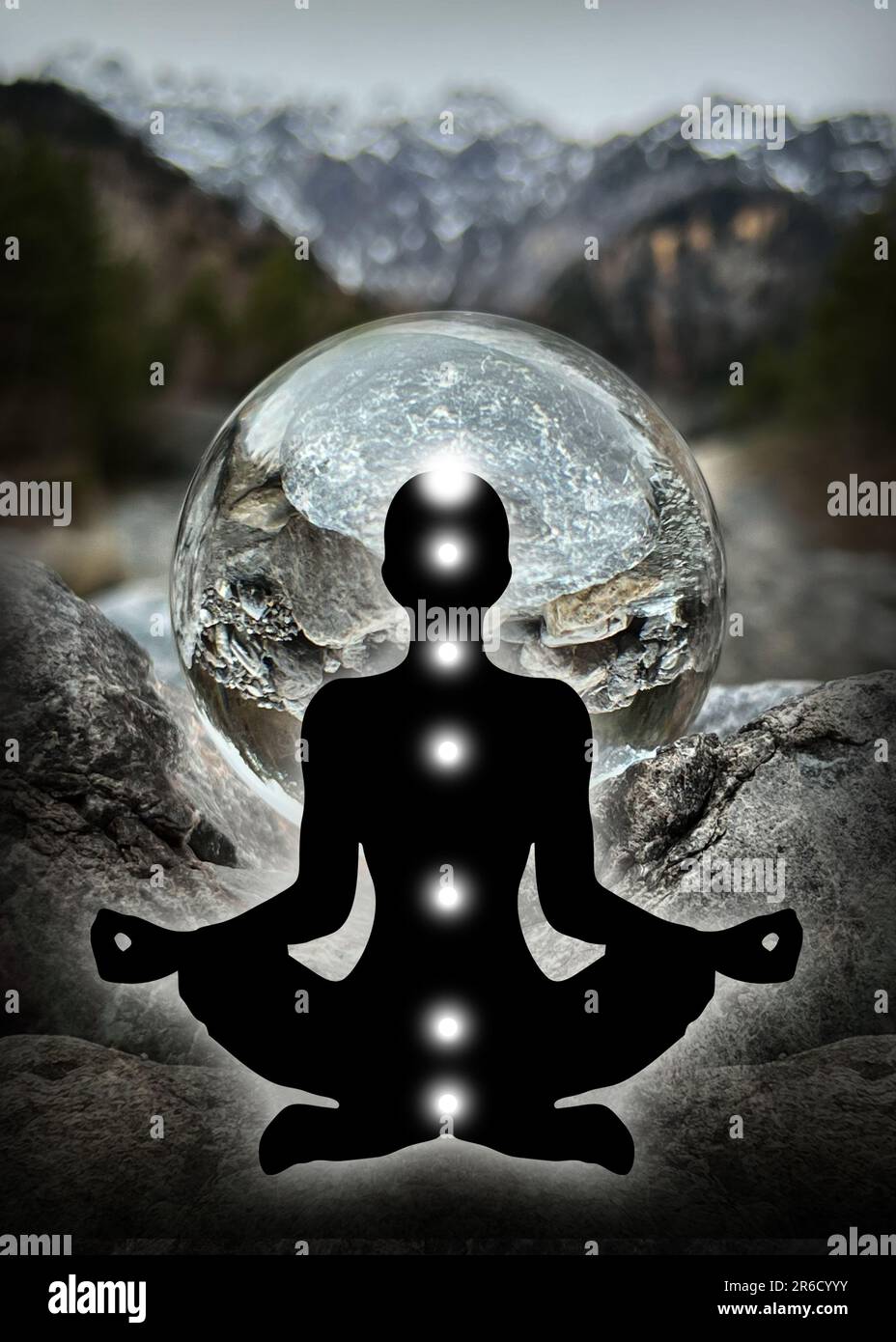Human silhouette in yoga, lotus pose (human energy body, aura) in front of lensball, crystal ball (austrian alpine creek/landscape, Montafon) Stock Photo