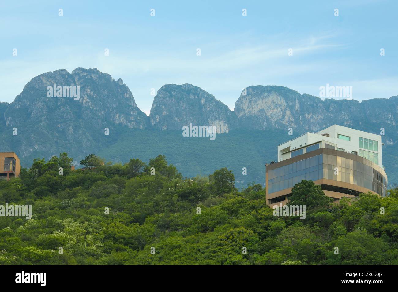 Beautiful view of building and green plants near mountains Stock Photo