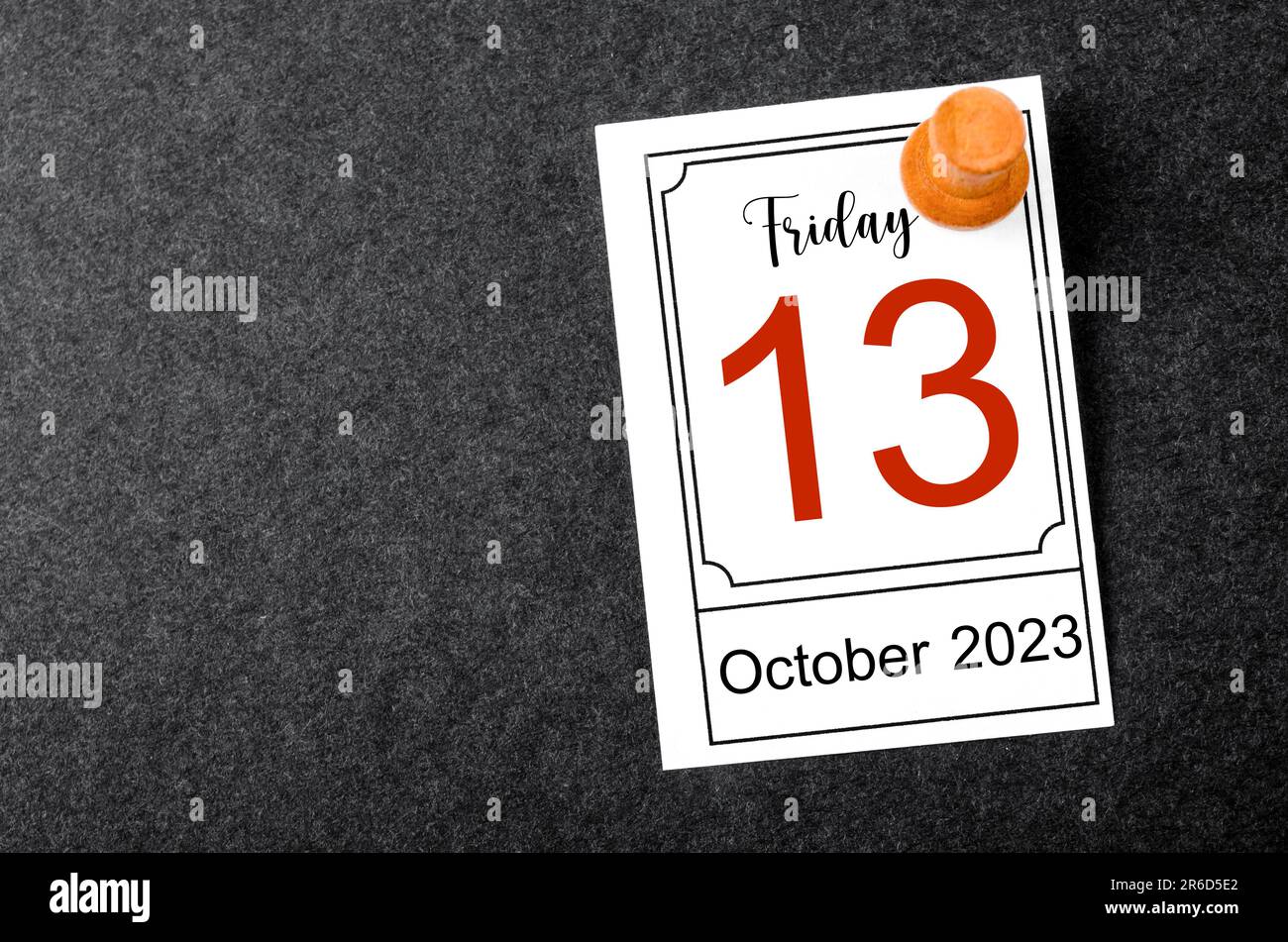 Friday the 13th calendar with wooden push pin on black background Stock