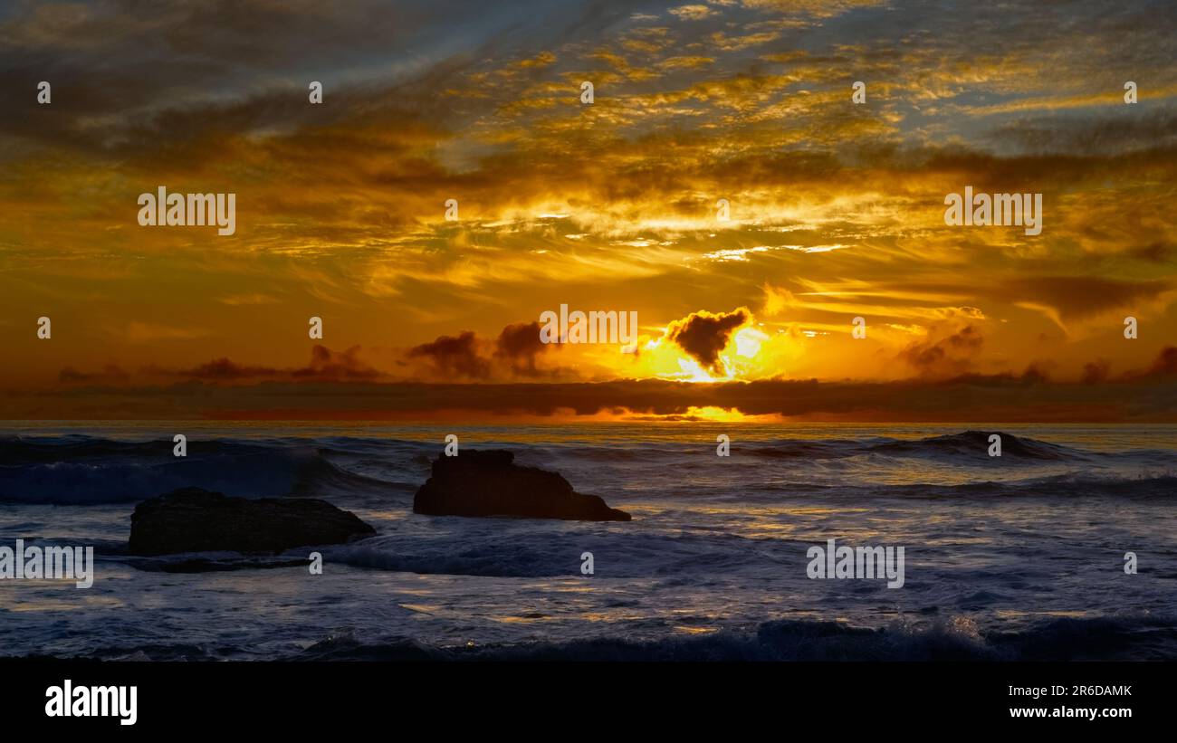 Sunset red clouds over the coast line. Stock Photo