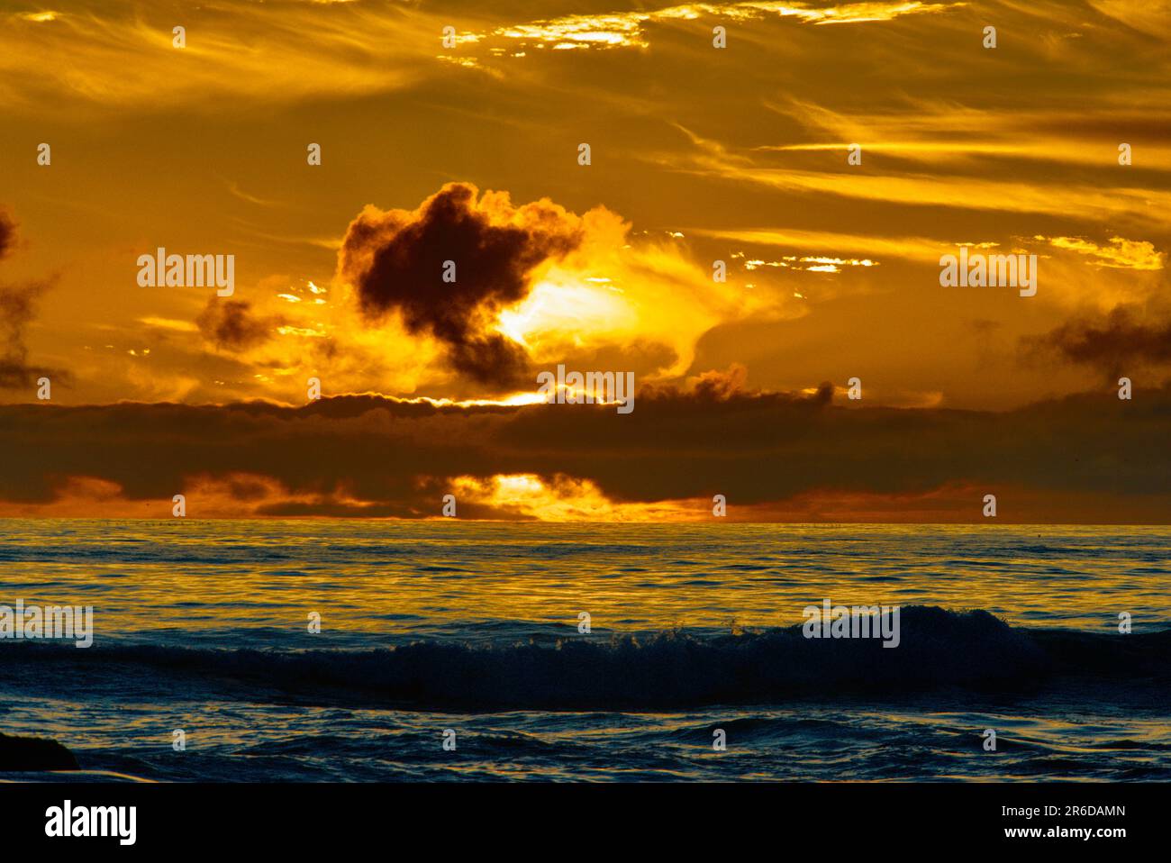 Sunset red clouds over the coast line. Stock Photo
