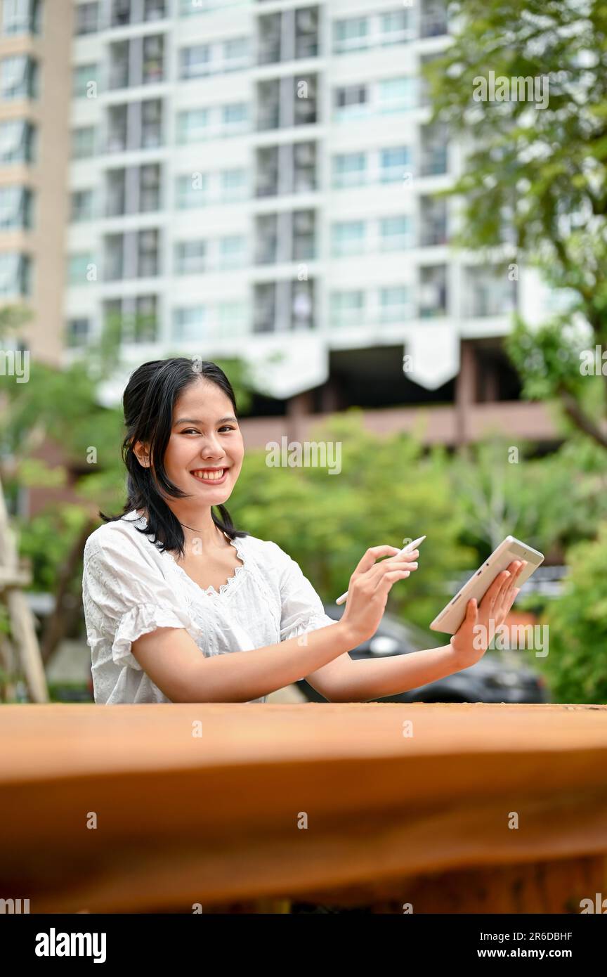 Portrait of an Asian woman with sportswear sitting on the balcony