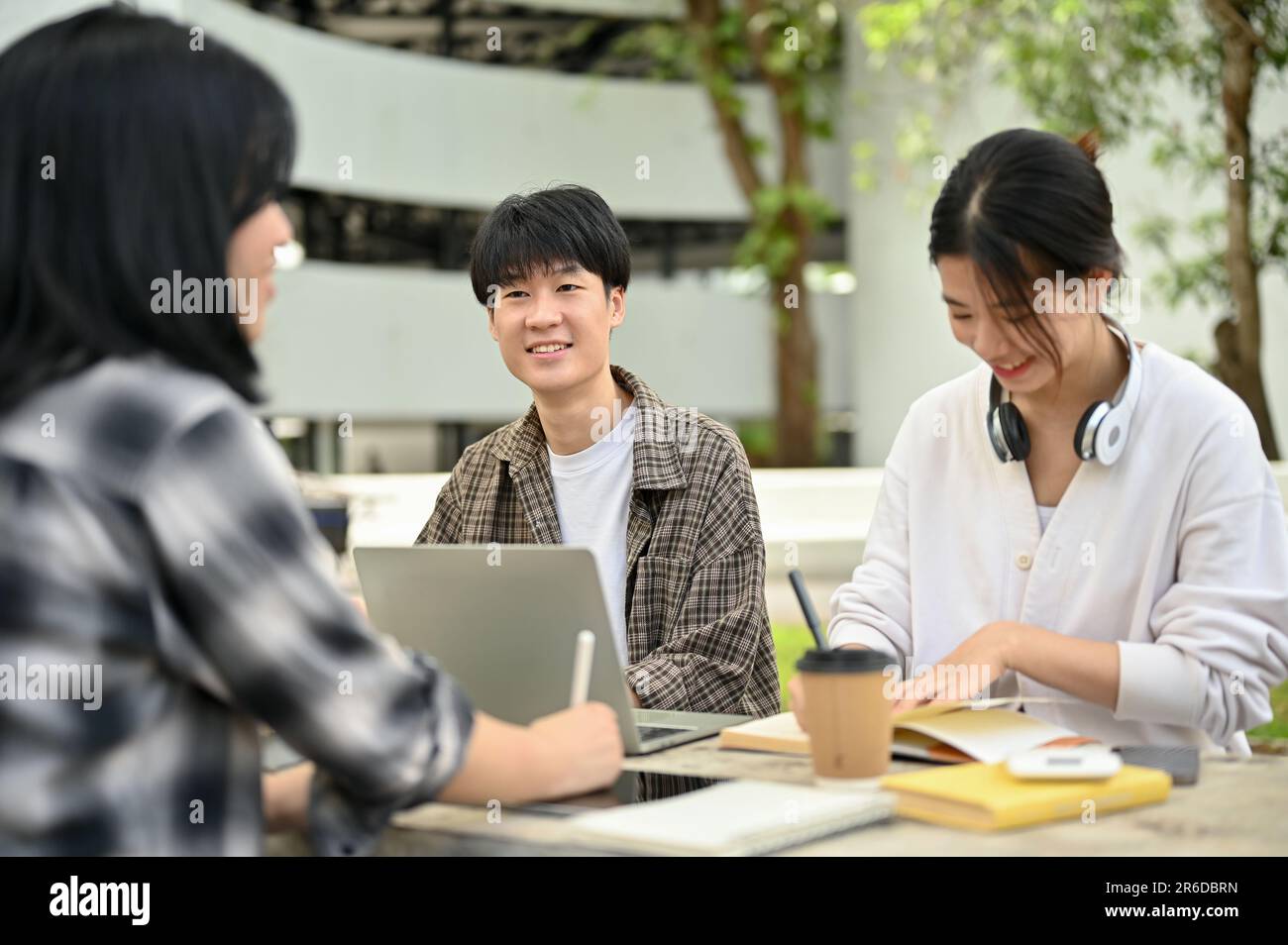 A positive and handsome young Asian male college student is listening ...