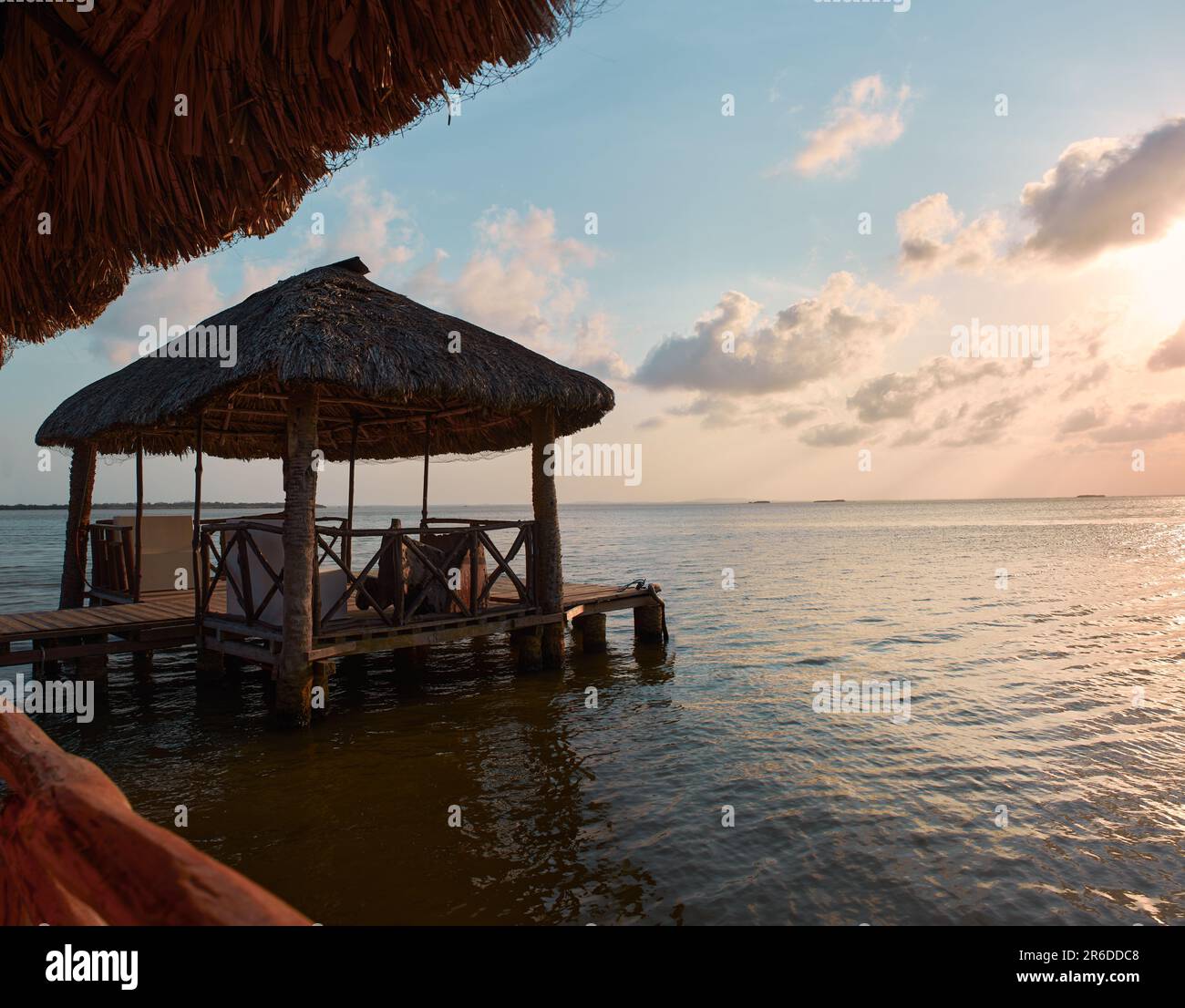 wooden dock with thatched roof, traditional Mexican design in the summer sunset with the lake of Old Town city in the background without boats, no peo Stock Photo