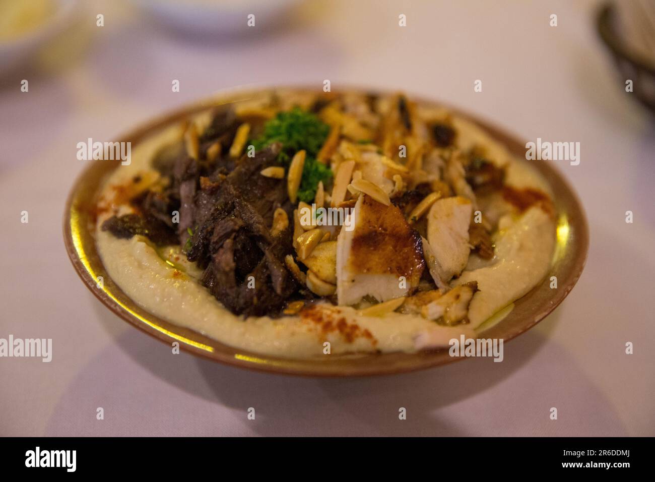Loaded Hummis with Beef and chicken with pine nuts Stock Photo