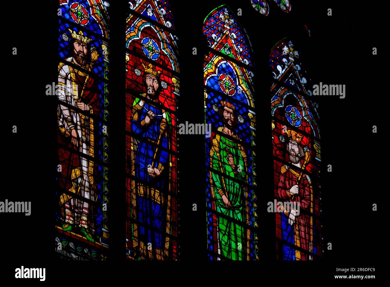 Colorful medieval era stained glass panels depicting monarchs, set in