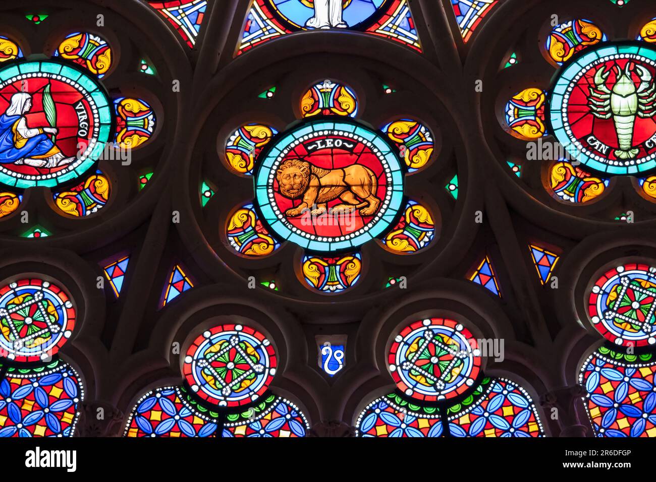 St. Denis Basilica Paris France. Colorful zodiac symbols depicted in a stained glass window in a medieval cathedral including Leo, Virgo, Cancer and Stock Photo