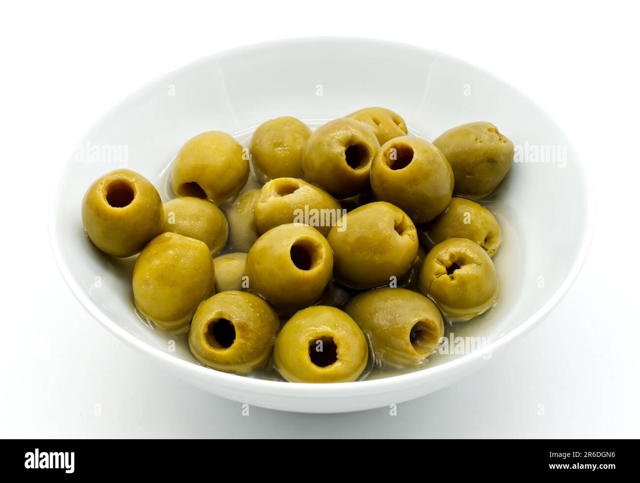 Pitted green olives in a bowl isolated on white Stock Photo