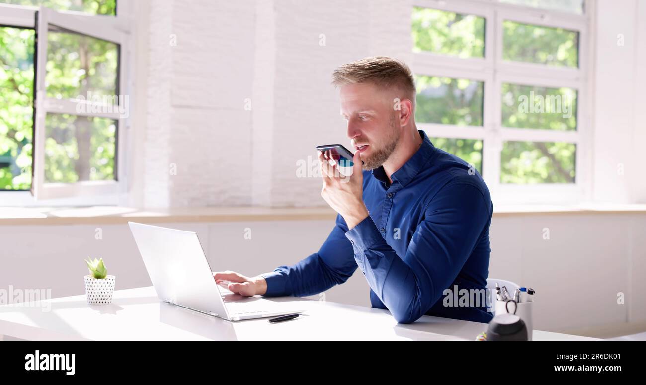 Young Man Using Voice Recognition Function On Mobile Phone Stock Photo