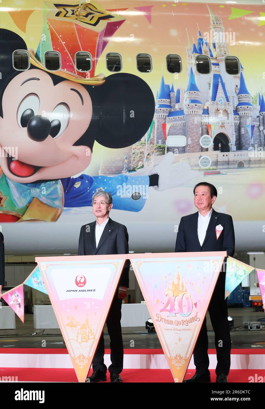 Tokyo, Japan. 9th June, 2023. Japan Airlines (JAL) president Yuji Akasaka (L) and Tokyo Disney Resort operator Oriental Land president Kenji Yoshida (R) with their employees display the 'JAL Colorful Dreams Express' jetliner to celebrate the Disneyland's 40th anniversary at a JAL hangar at the Haneda airport in Tokyo on Friday, June 9, 2023. The new Disney characters designed Boeing 767 launched JAL's domestic routes. (photo by Yoshio Tsunoda/AFLO) Stock Photo