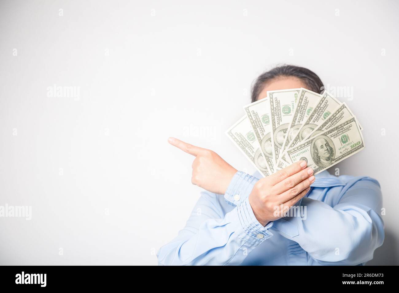 Woman holding fan of dollar hi-res stock photography and images - Alamy