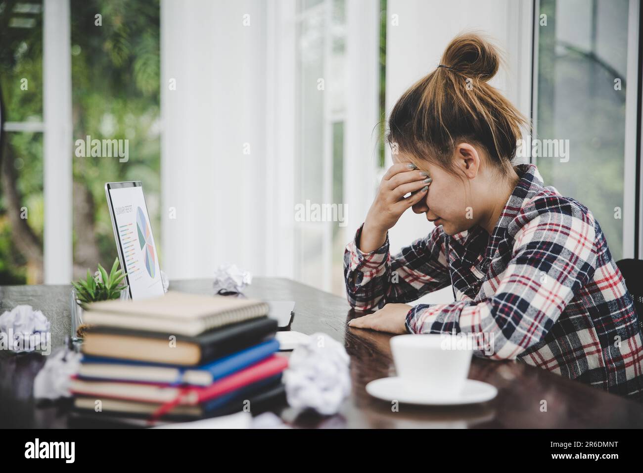 woman sitting down, his face unsettled. At the computer desk she has