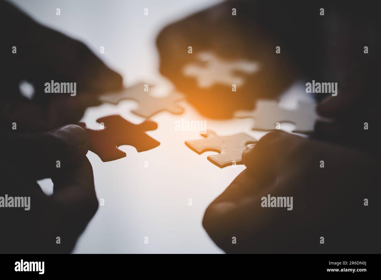Hands holding piece of blank jigsaw puzzle for teamwork workplace ...