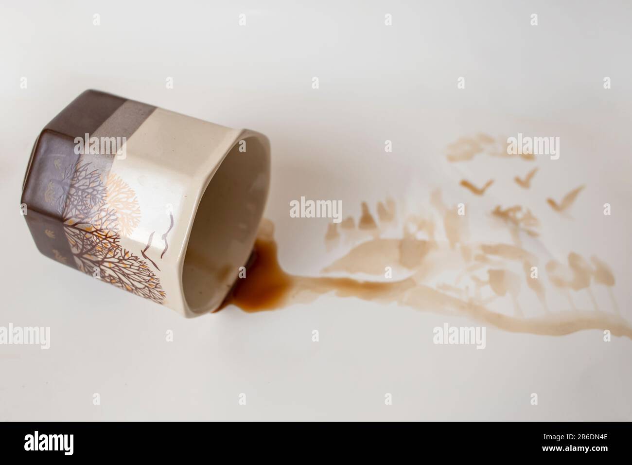 brown coffee spill on white paper background, soft focus side view