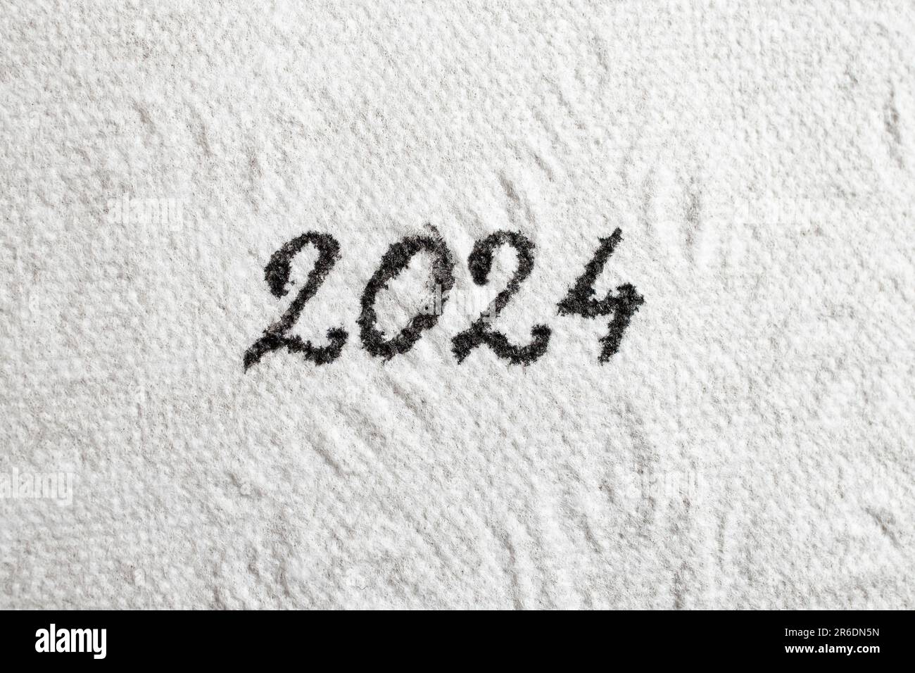 2024 number written with black ink on white tissue paper, Close up texture Stock Photo