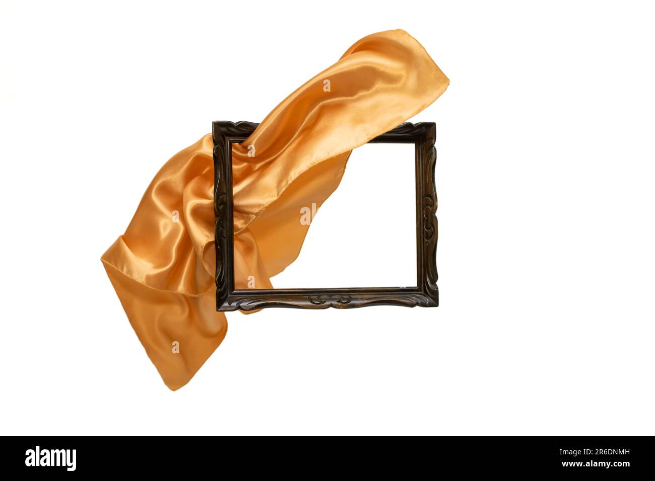 Golden satin cloth flying thru a wooden frame, motion blur unveiling product, abstract backdrop. Stock Photo