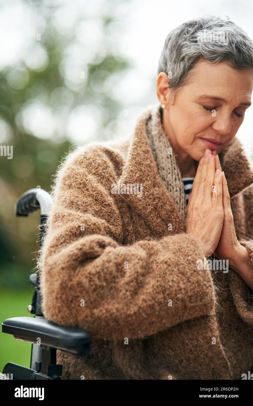 Senior woman in wheelchair, prayer outdoor with worship and God with peace,  religion with gratitude and faith. Spiritual female person with disability  Stock Photo - Alamy