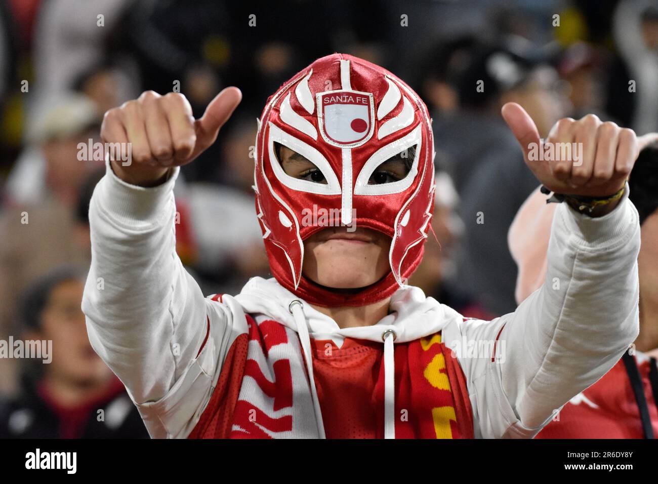 Bogota, Colombia. 08th June, 2023. A fan of Santa Fe uses a luchador mask with the team logo during the Peru's Universitario (0) V. Colombia's Santa Fe (2) group phase match of the CONMEBOL Libertadores, in Bogota, Colombia June 9, 2023. Photo by: Cristian Bayona/Long Visual Press Credit: Long Visual Press/Alamy Live News Stock Photo