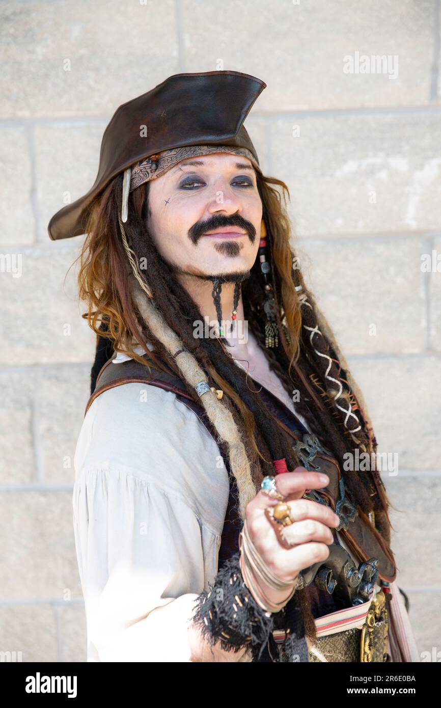 A portrait of a happy cosplay male dressed as the pirate Captain Jack Sparrow from the Pirates of the Caribbean movie Stock Photo