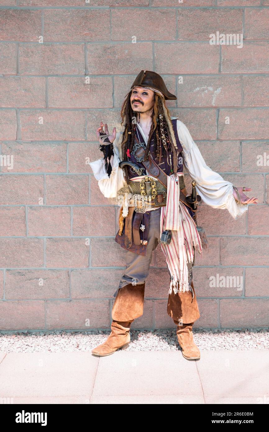 A full length portrait of a happy cosplay male dressed as the pirate Captain Jack Sparrow from the Pirates of the Caribbean movie at a UK Comic Con Stock Photo