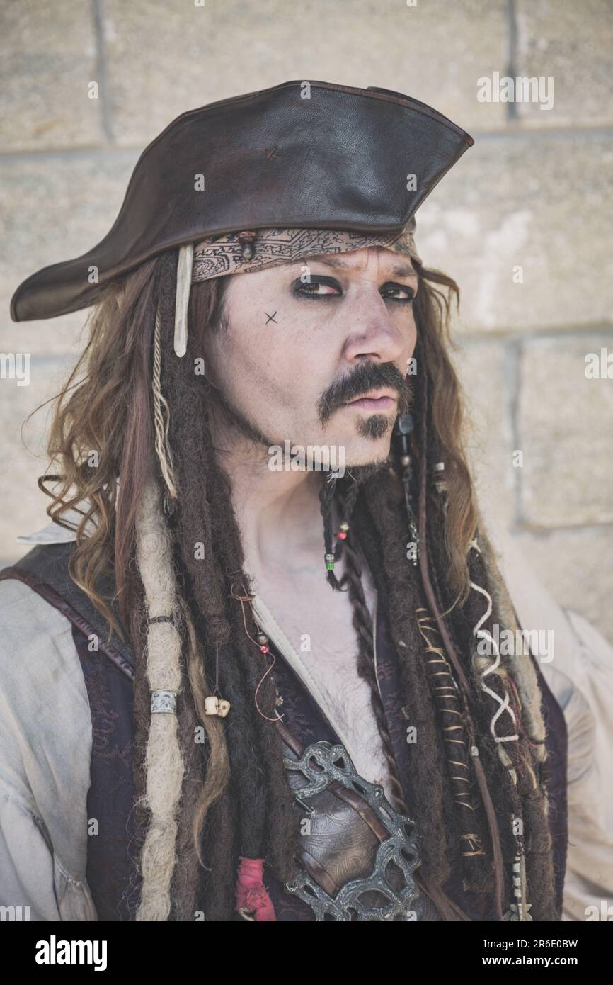 A portrait of a happy cosplay male dressed as the pirate Captain Jack Sparrow from the Pirates of the Caribbean movie at a UK Comic Con Stock Photo