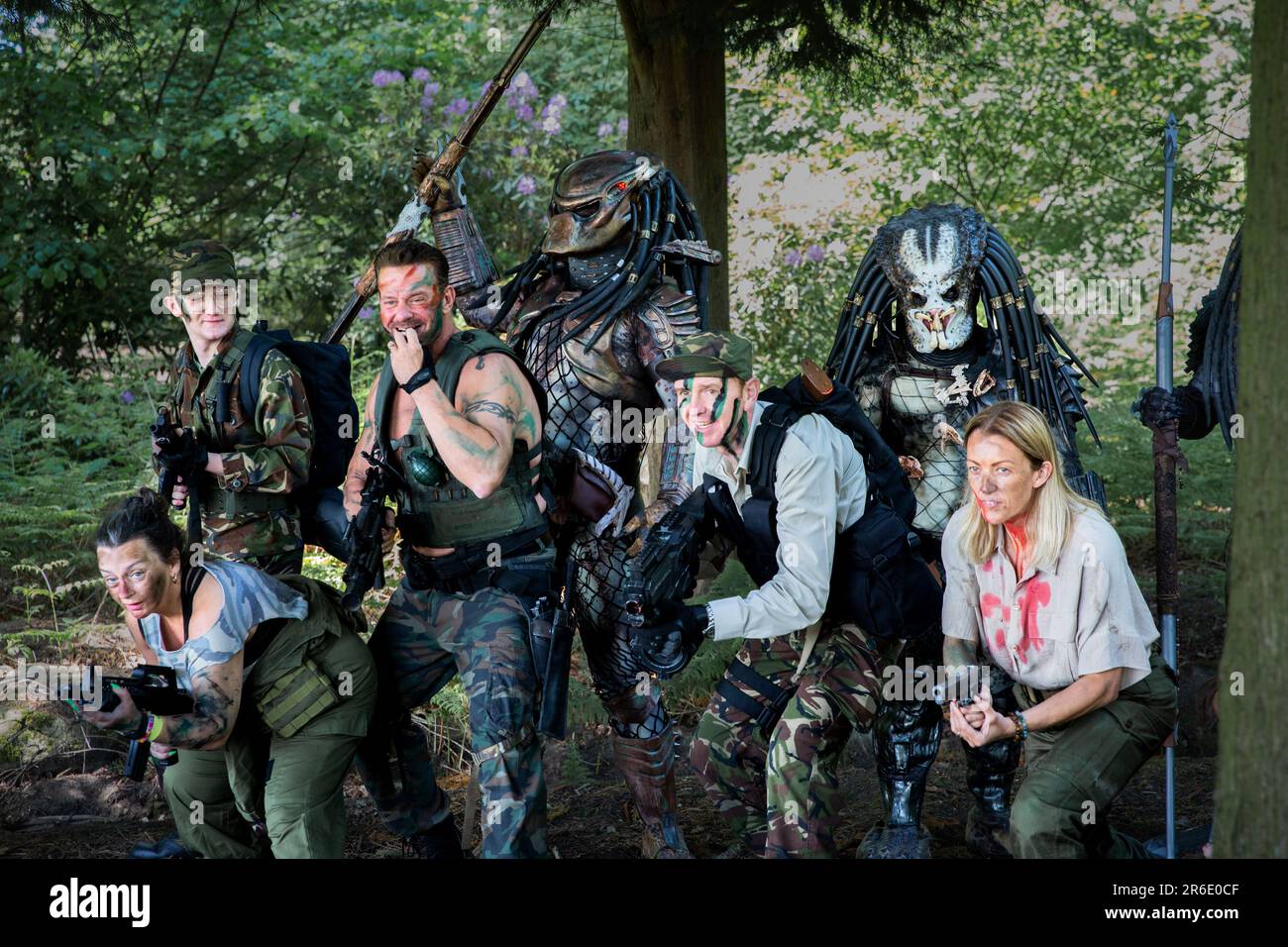 HARROGATE, UK - JUNE 3, 2023.  A group of cosplay friends dressed as alien Predator and Arnold Schwarzenegger from the movie franchise in realistic co Stock Photo