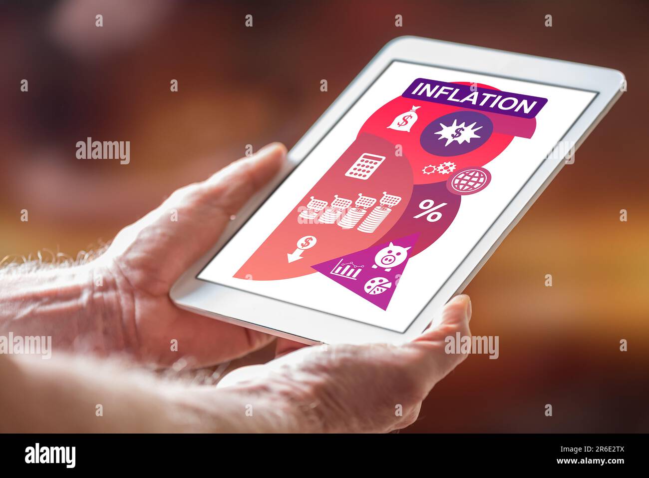 Man holding a tablet showing inflation concept Stock Photo
