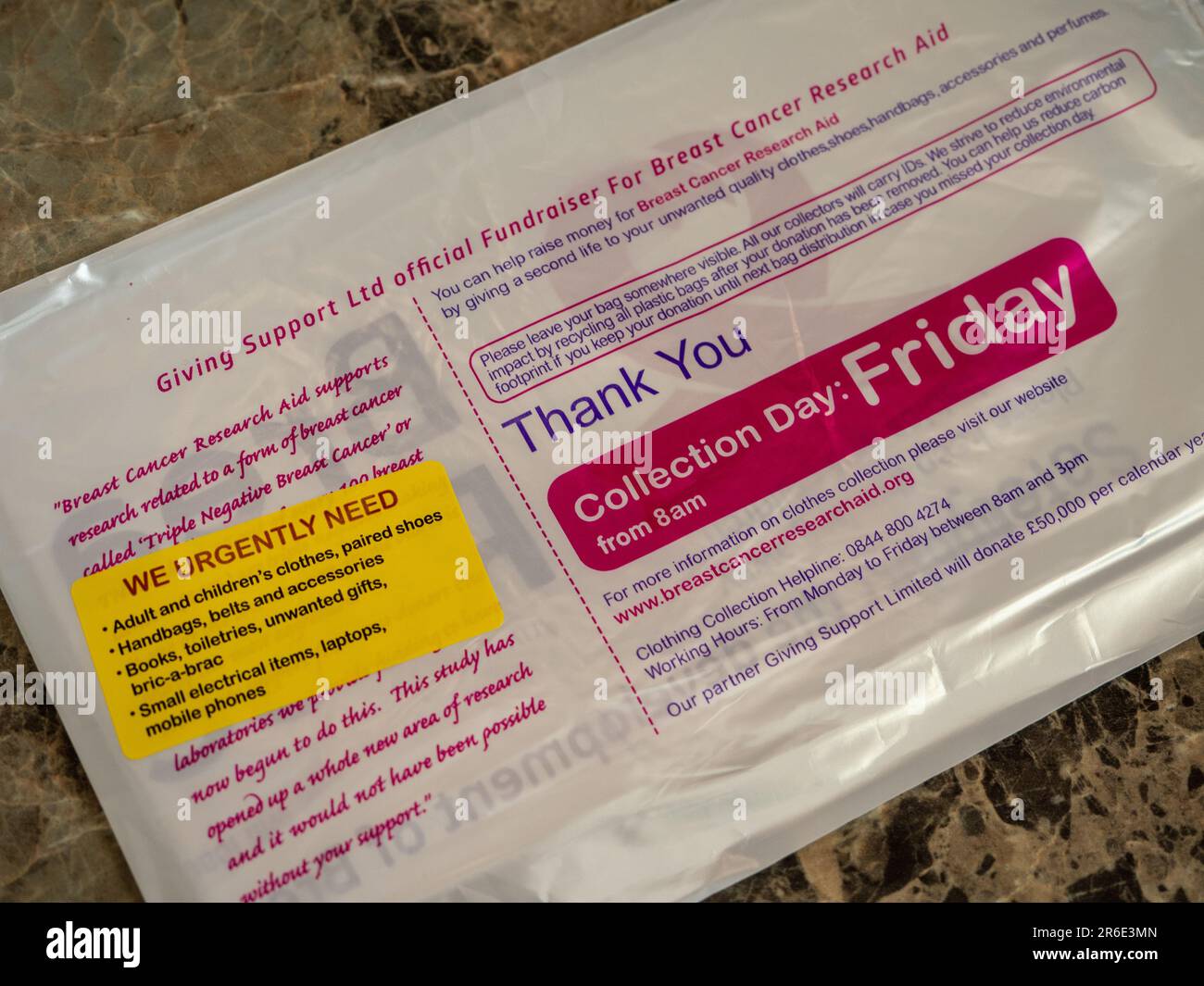 Charity collection bag for Breast Cancer Research Aid delivered to a UK home. Stock Photo