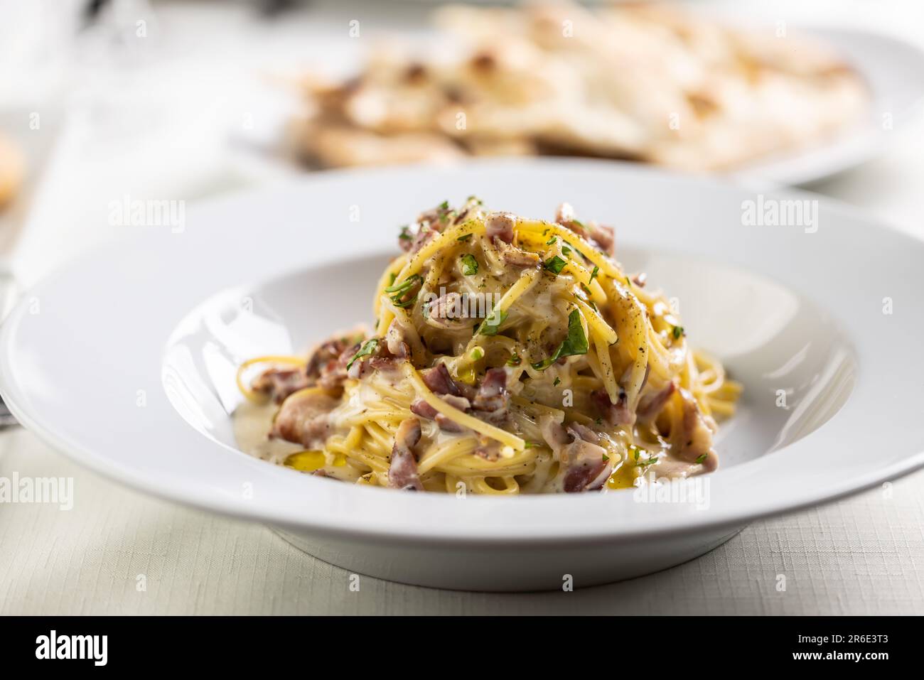 Spaghetti carbonara made with fried bacon cubes, yellow sauce from eggs ...