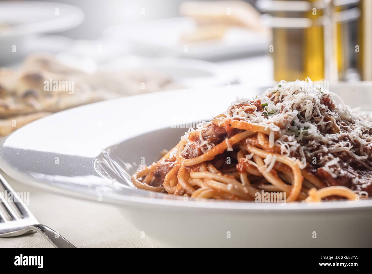 Detail of spaghetti with tomato sauce, basil, and parmesan on top. Stock Photo