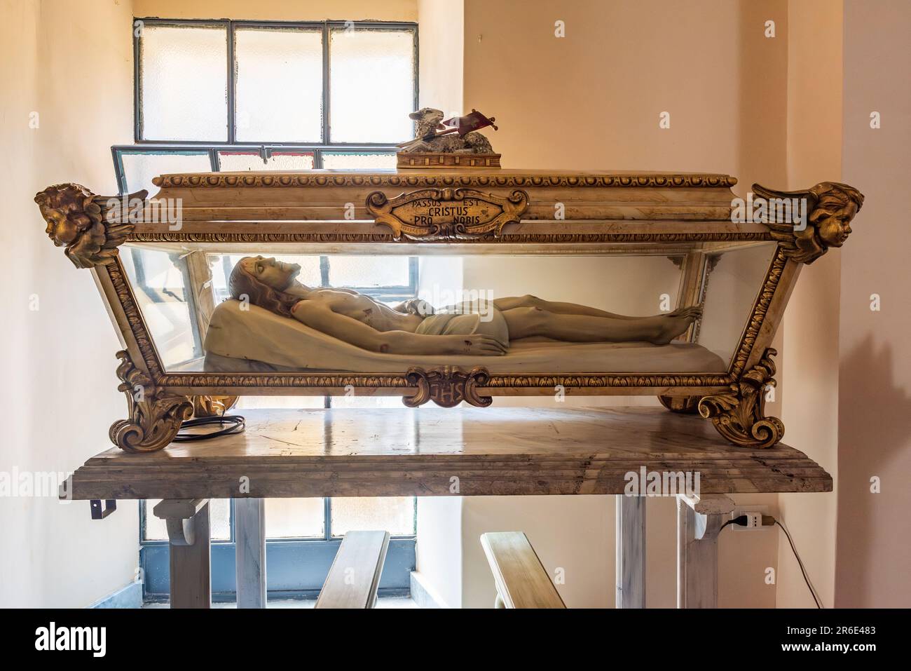 A life-sized effigy of the dead body of Jesus is displayed lying in a glass coffin, in the small village church of Motta Camastra, Sicily, Italy Stock Photo