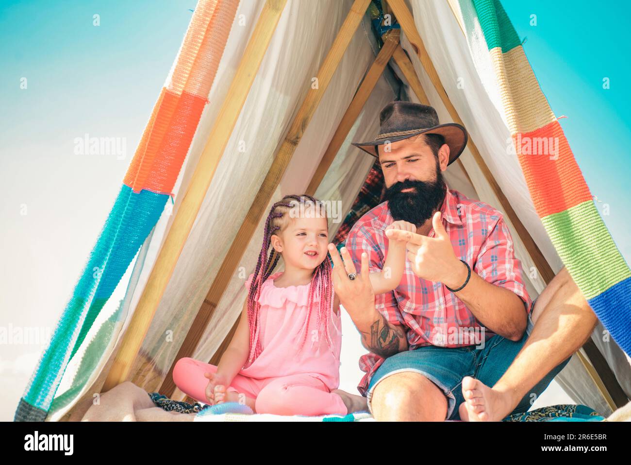 Family outdoor activity. Dad and child daughter at camping vacation