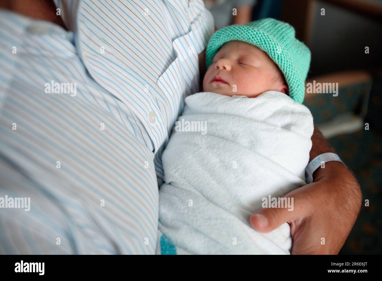A father holds his new born daughter the day after she was born. Stock Photo