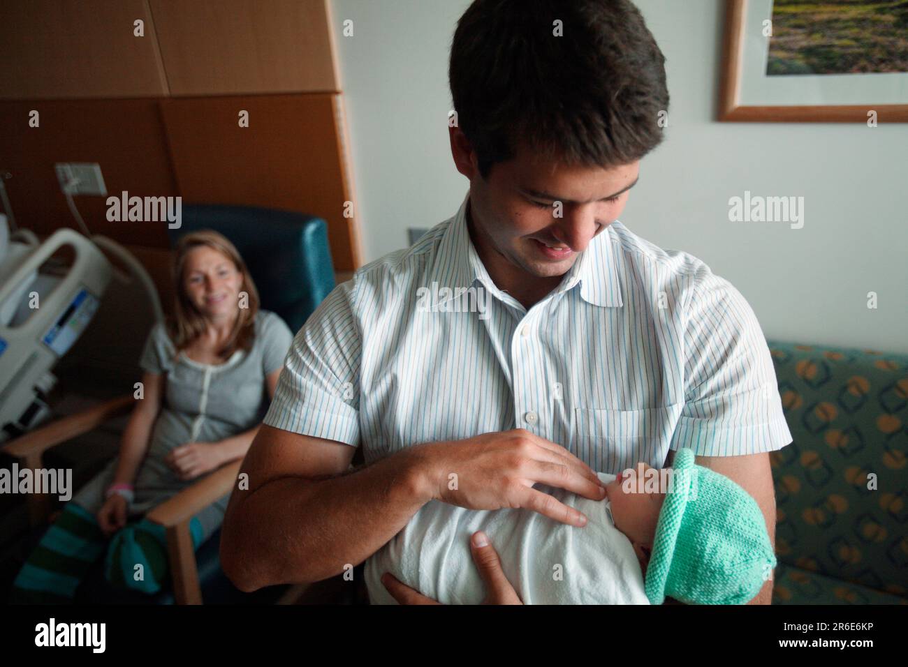 A father holds his new born daughter the day after she was born Stock ...