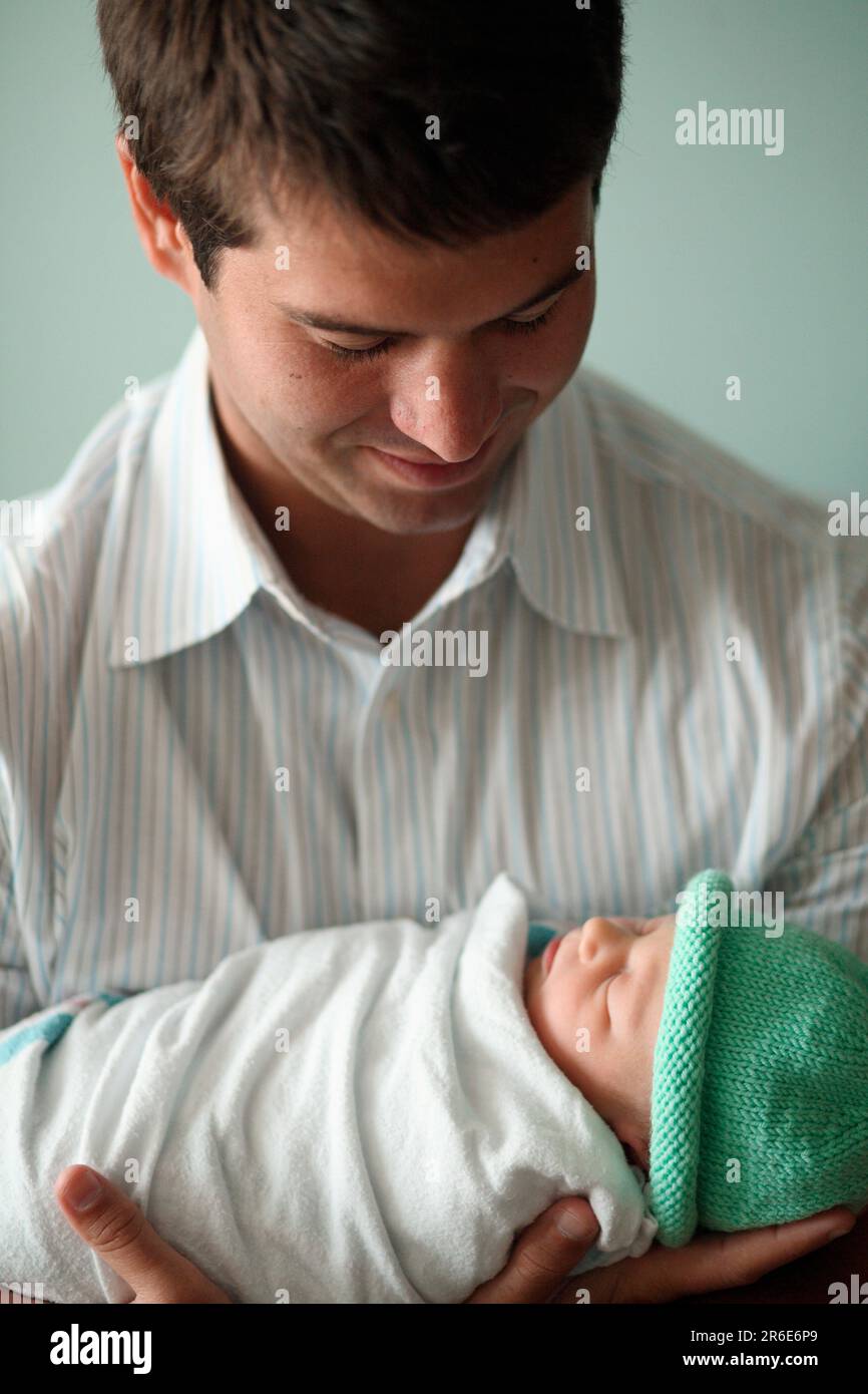 A father holds his new born daughter the day after she was born Stock ...