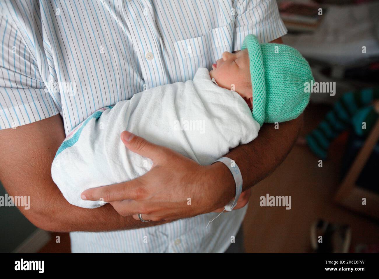 A father holds his new born daughter the day after she was born. Stock Photo