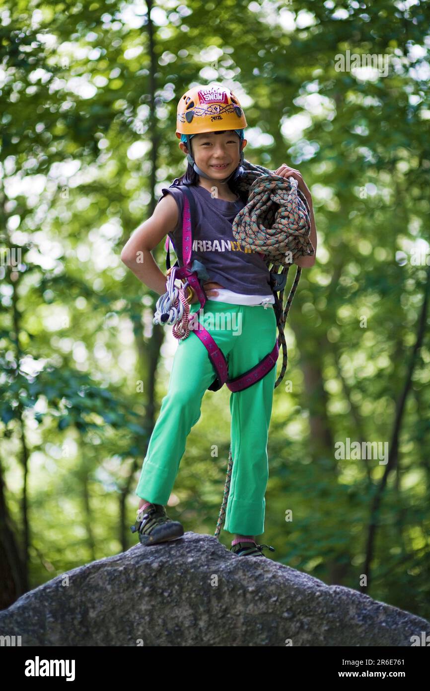 A portrait of a young Asian girl rock climbing at the Shawagunks in New
