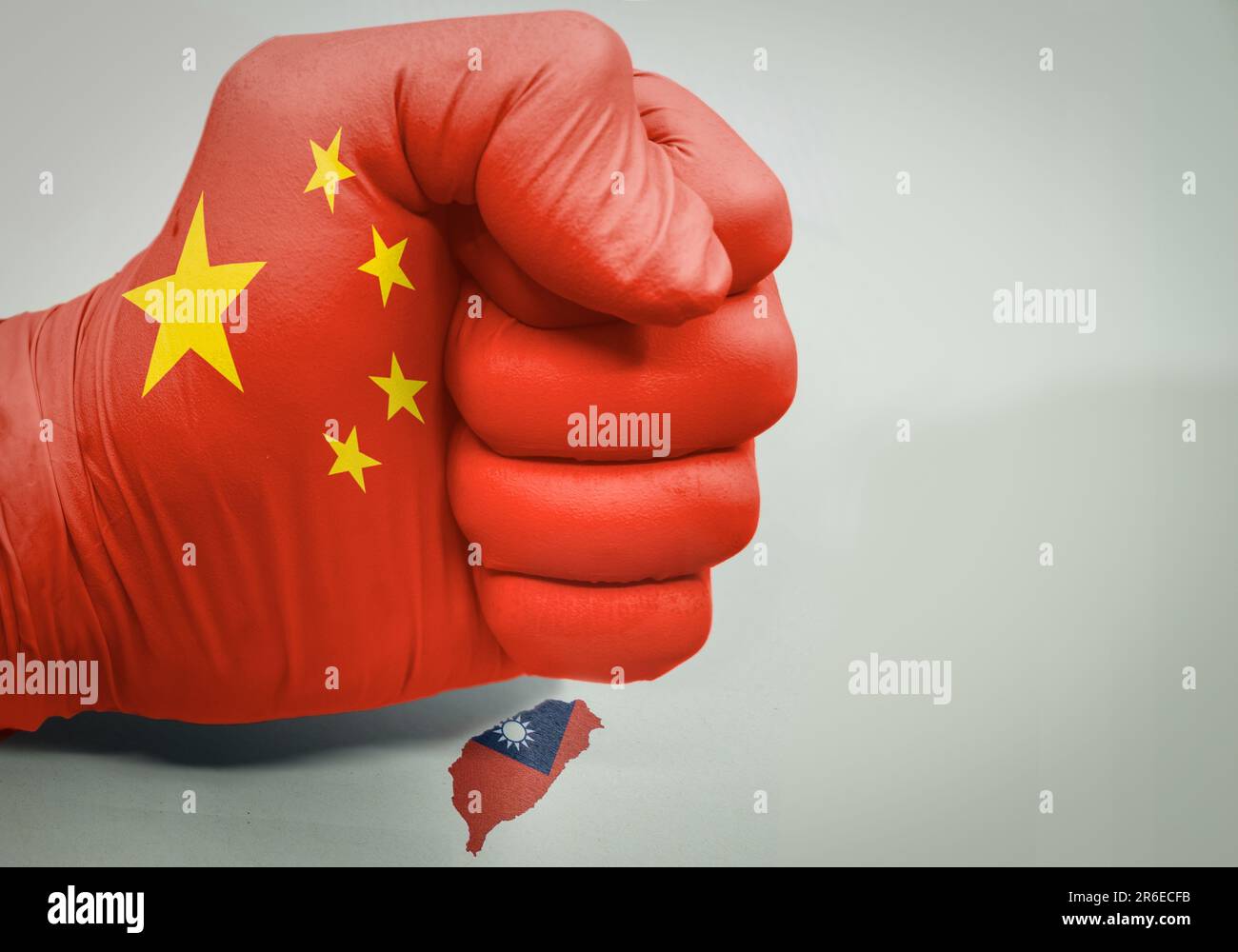 Fist with the colors of the flag of china crushing the island of taiwan