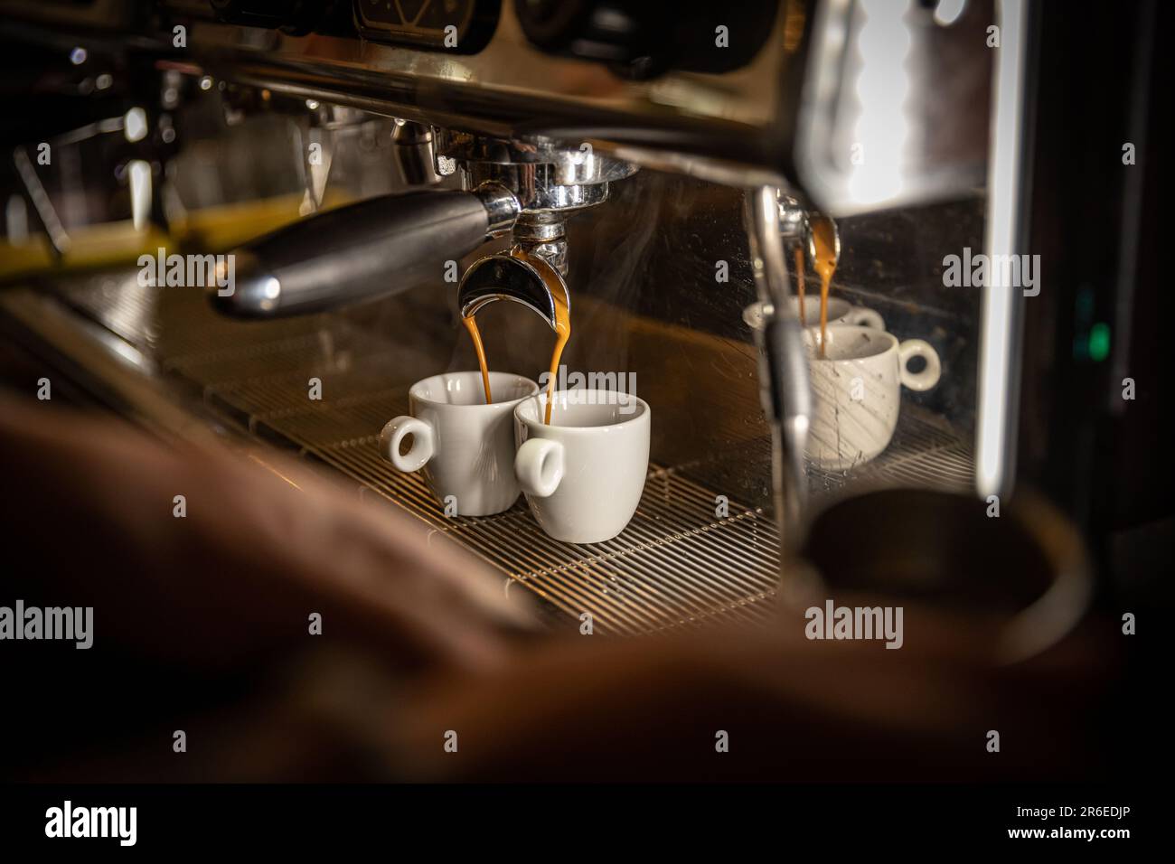 Espresso machine pouring coffee in white cups Stock Photo