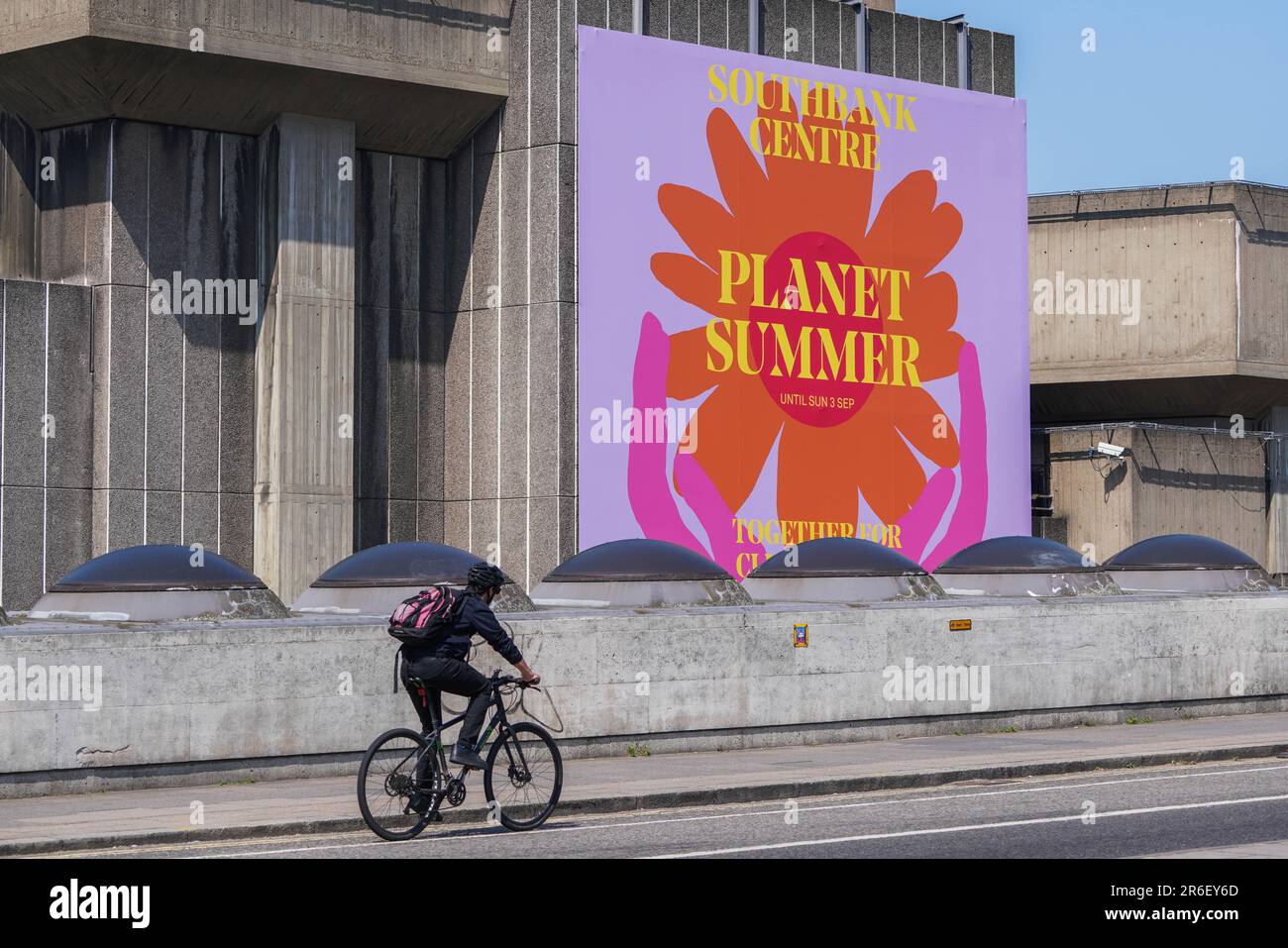 London UK. 9 June 2023 . A cyclist rides on Waterloo bridge on a hot and sunny morning past a large billboard promoting  Planet Summer together about climate hope . A heat-health alert has been issued for parts of England as temperatures are predicted to hit 30C (86F) over the weekend due to the arrival of an “Iberian plume” that will bring warm air from Spain Credit: amer ghazzal/Alamy Live News Stock Photo