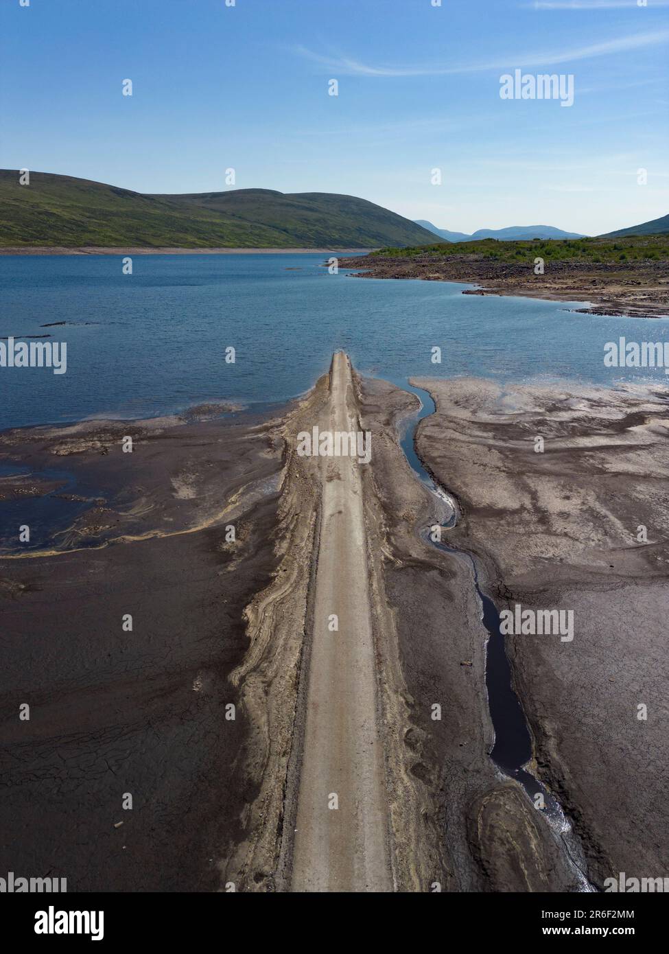 Garve, Scotland, UK. 9th June 2023. Low water levels in Loch Glascarnoch reservoir near Garve south of Ullapool have revealed the route of the old road from Ullapool to Dingwall. The road and bridges are normally submerged under water, however recent drought conditions have led to warnings of possible water restrictions. Iain Masterton/Alamy Live News Stock Photo