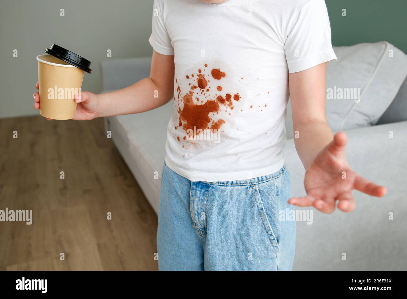 The child spilled coffee on his clothes. The concept of a stain on a t