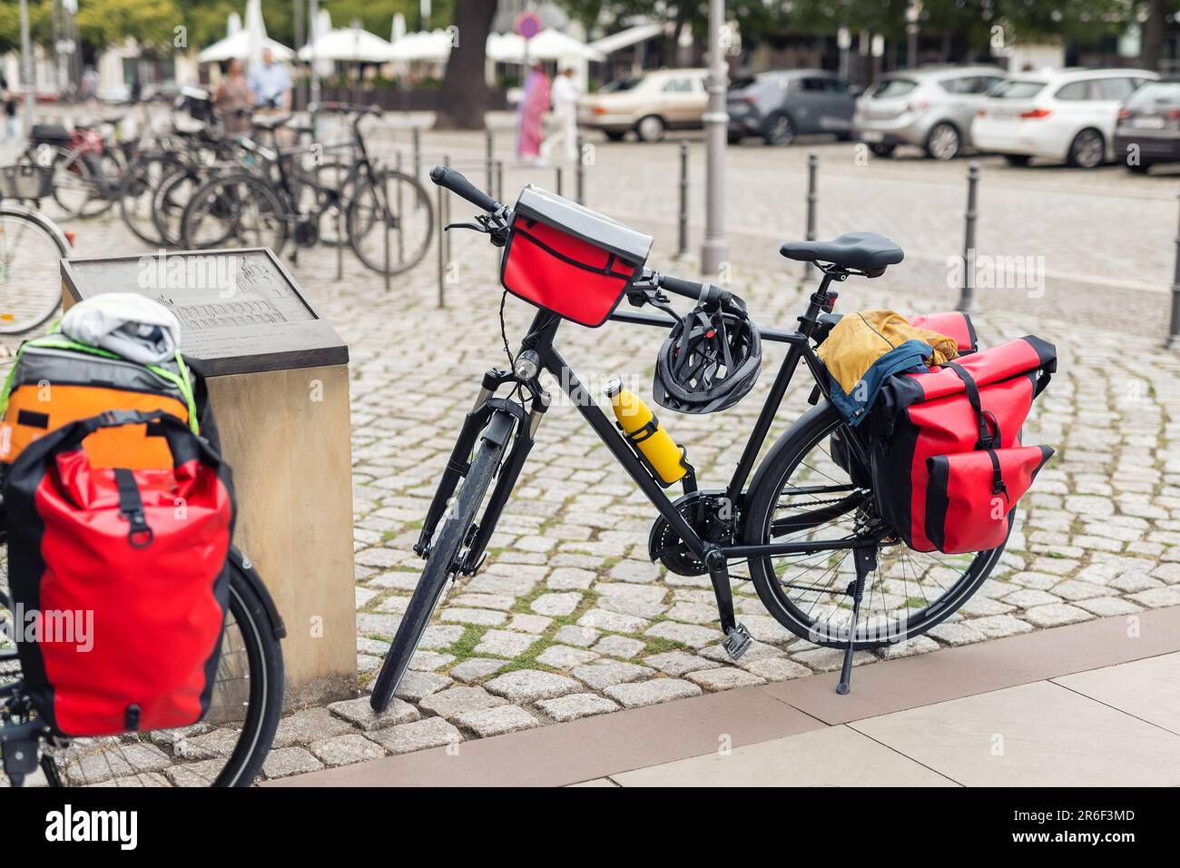 Many modern bicycles with travel luggage bags equipment parked in old european city center street. Healthy eco sustainable tourism family trip Stock Photo