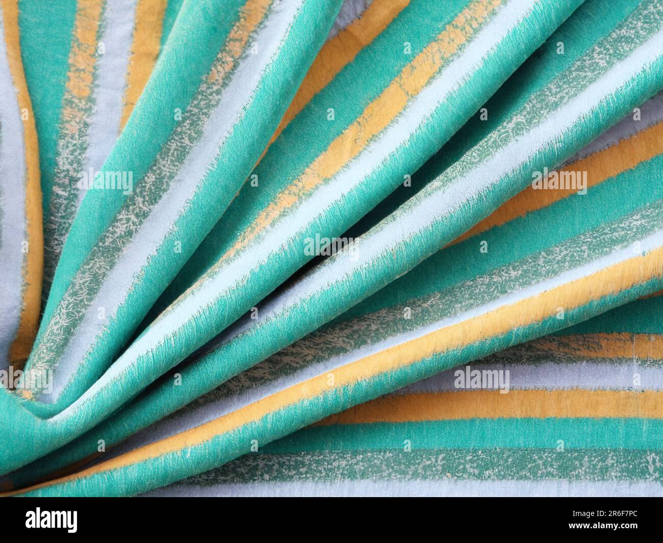 a close up of a green, yellow and blue fabric. . Stock Photo