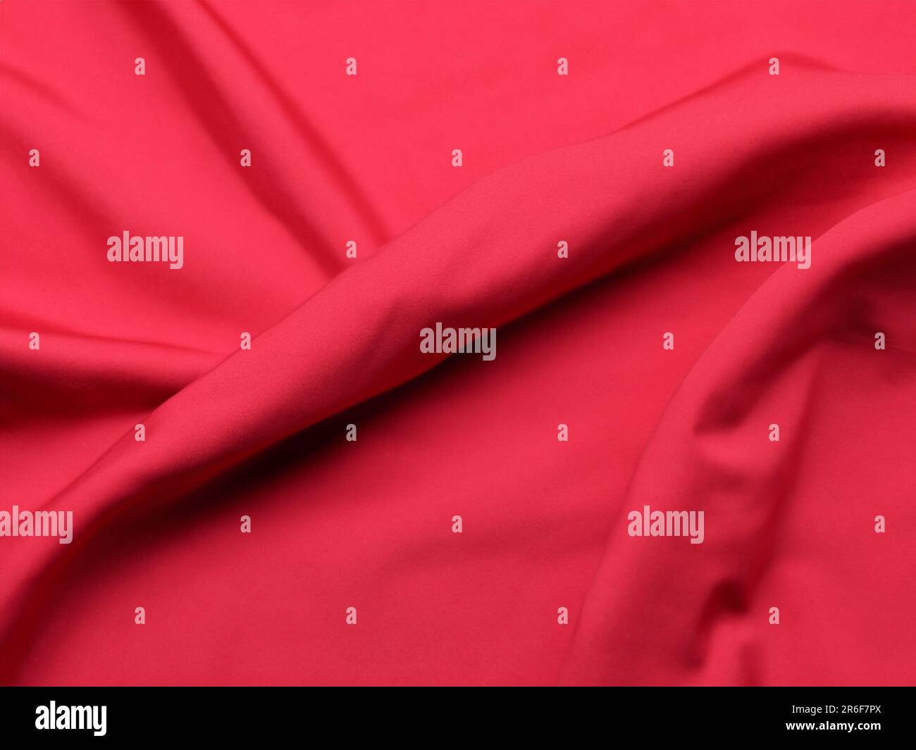a close up of a red fabric with a very soft feel. . Stock Photo