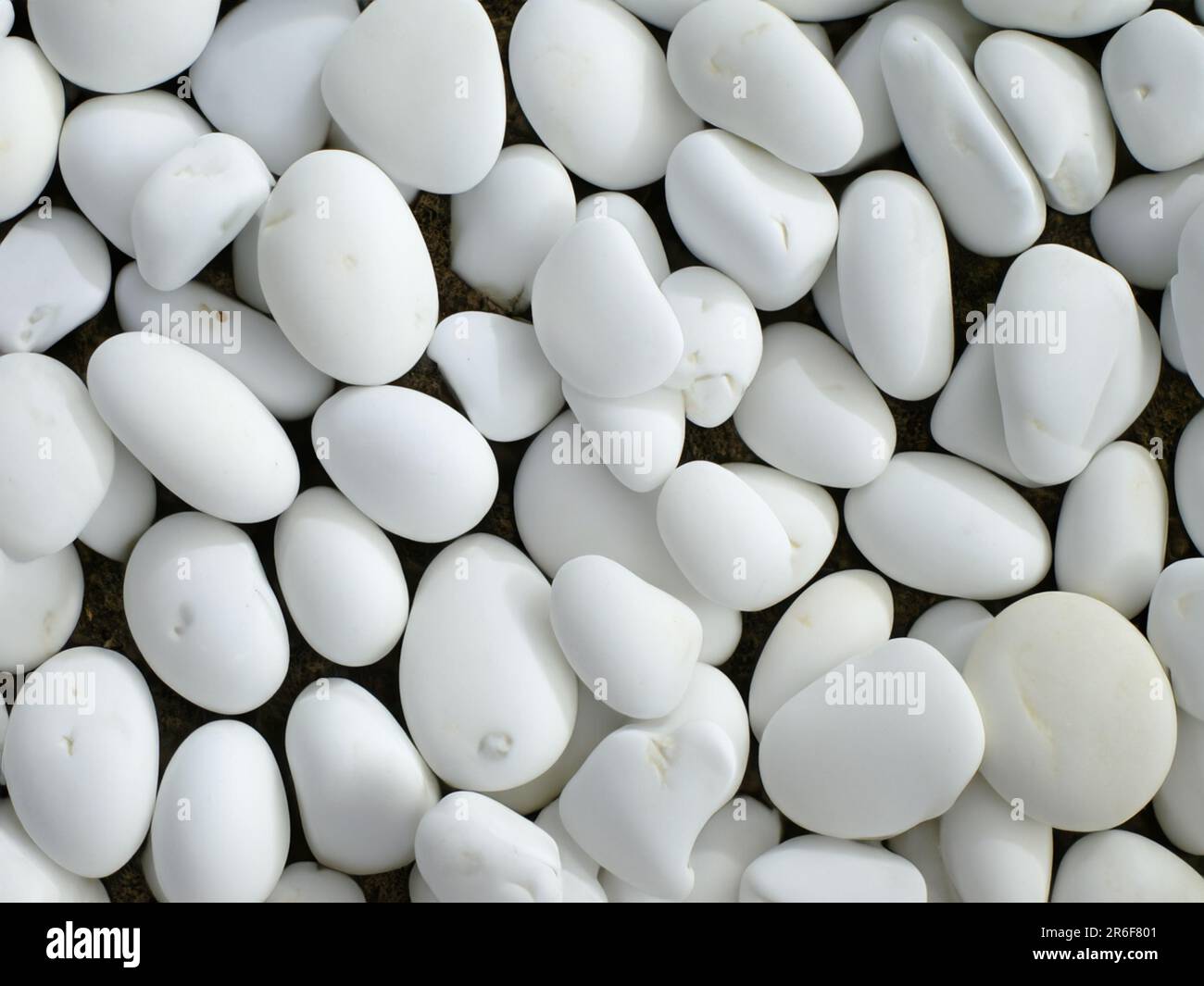 a close up of a bunch of white rocks on the ground. . Stock Photo