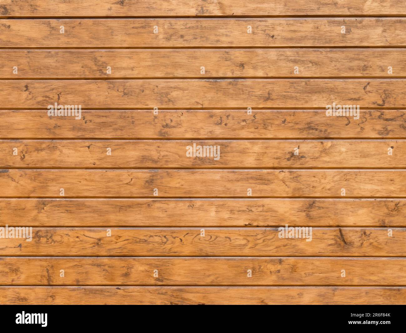 a brown wooden wall with a clock on the top of it. . Stock Photo