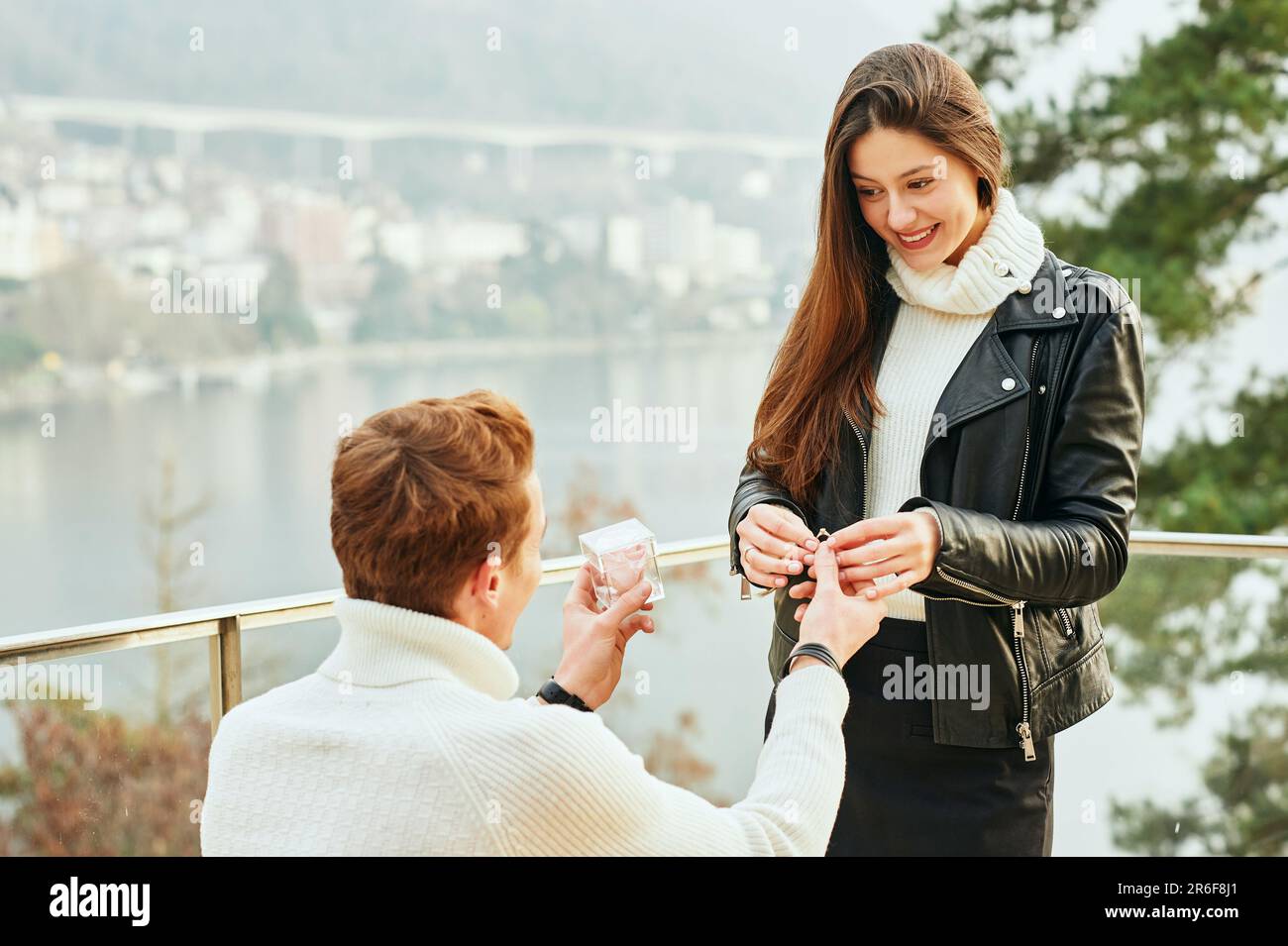 Young man with engagement ring making proposal to his girlfriend Stock Photo