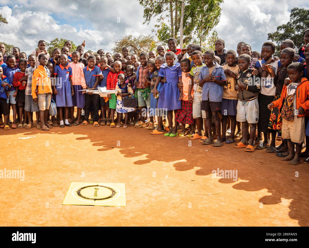 Schoolchildren at a Malawian school watch as a UAV (drone) takes off